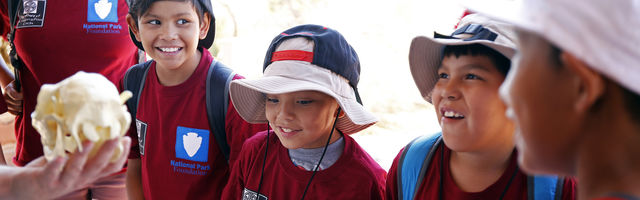 4 young members smiling in a circle